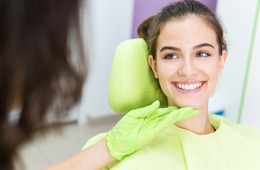 A young woman smiling in the dentist’s chair