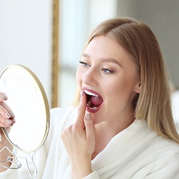 Patient Concord checking their teeth in a mirror