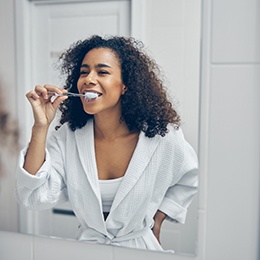 Patient in Concord brushing their teeth to prevent dental emergencies